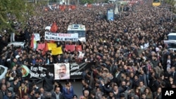 Thousands of people march during the funeral of Tahir Elci, president of the Diyarbakir Bar Association and a leading human rights defender, in Diyarbakir, Turkey, Nov. 29, 2015. Elci was killed Saturday while making a press statement intended to call attention to damage done to the 1,500-year-old Four-Legged Minaret Mosque by recent clashes between Turkish security forces and Kurdistan Workers' Party militants. The banner in Turkish and Kurdish reads: " We will not forget you."