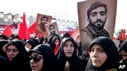 Thousands of Iranians attend the state funeral of Mohsen Hojaji, a young Revolutionary Guard soldier beheaded by the so-called Islamic State group in Syria, Wednesday, Sept. 27, 2017, in Tehran, Iran. 