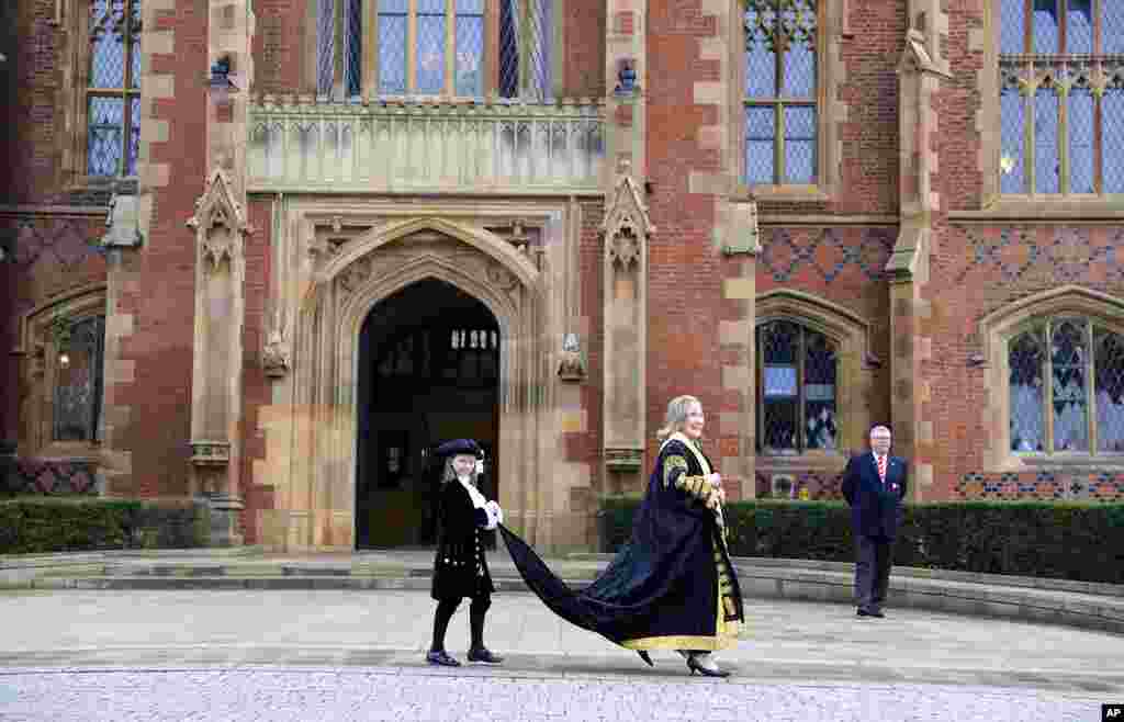 Former U.S. Secretary of State Hillary Clinton poses for a photo after being inaugurated as the first female chancellor of Queens University, in Belfast, Northern Ireland.