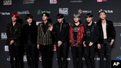FILE- Members of South Korean music band BTS pose for photos on the red carpet of the Mnet Asian Music Awards (MAMA) in Hong Kong, Dec. 14, 2018. 