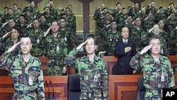 South Korea's Army Chief of Staff, Kim Sang-ki, center, salutes with other military members during the commanders meeting at the Army headquarters in Daejeon, south of Seoul, South Korea, 30 Dec 2010
