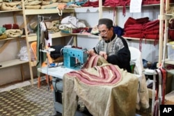 A tailor sews costumes for the TV series "A.D." in Ouarzazate, not far from where it's being filmed, Jan. 30, 2015.