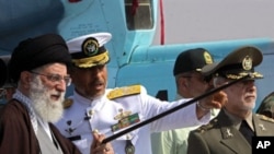 A handout picture made available by the official website of Iranian Supreme Leader Ayatollah Ali Khamenei, shows the later (L) touring "Jamran", Iran's first domestically built warship, during its unveiling ceremony at an undisclosed location in southern 