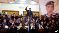 Supporters and family members of Jordanian pilot, Lt. Muath al-Kaseasbeh, express their anger of his reported killing, at the tribal gathering chamber, Amman, Jordan, February, 3, 2015. 