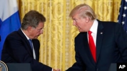 President Donald Trump shakes hands with Finnish President Sauli Niinisto during their joint news conference, Aug. 28, 2017, in the East Room of the White House in Washington.