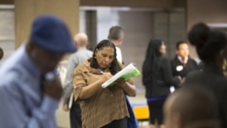 USA, Los Angeles, Malana Long fills out a job application during a job fair