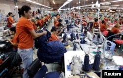 Paraguayan workers assemble clothes for Brazilian retailer Riachuelo at the factory of Texcin in Limpio, Paraguay Dec. 20, 2016.