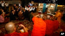 The 10th-century Cambodian sandstone statues from the Metropolitan Museum of Art in New York is blessed by Cambodian Buddhist monks in Phnom Penh, Cambodia, June 11, 2013.