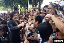 FILE - Ousted former Thai Prime Minister Yingluck Shinawatra greets supporters as she leaves the Supreme Court in Bangkok, Thailand, Aug. 1, 2017.