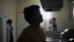 A breast cancer patient undergoes a mammography examination.