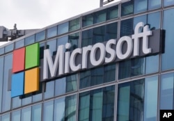 FILE - This April 12, 2016 file photo shows the Microsoft logo in Issy-les-Moulineaux, outside Paris, France.