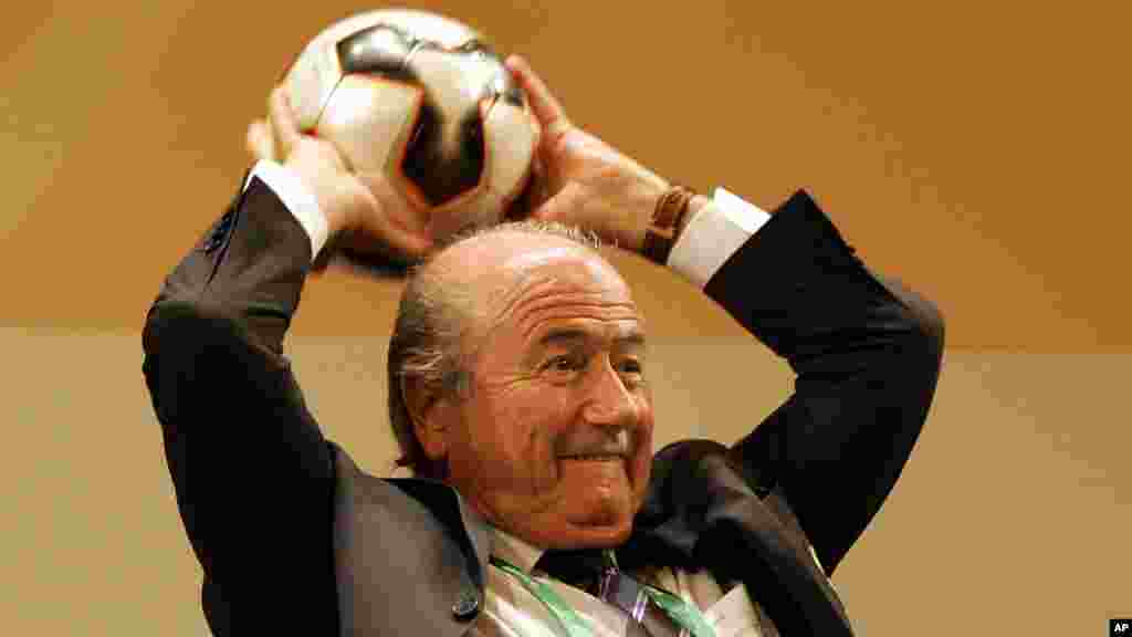 FIFA President Sepp Blatter prepares to throw a soccer ball to journalists at the end of a press conference in Leipzig, Germany Wednesday Dec. 7, 2005. Preparations are underway for the draw for the 2006 World Cup which will take place in Leipzig's famous