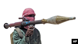 FILE - Al-Shabab Somali militiman displays weapon during exercises at training camp outside Mogadishu, Somalia.