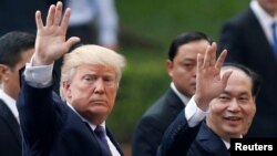 U.S. President Donald Trump and Vietnam's President Tran Dai Quang leave a news conference at the Presidential Palace in Hanoi, Vietnam, Nov. 12, 2017.