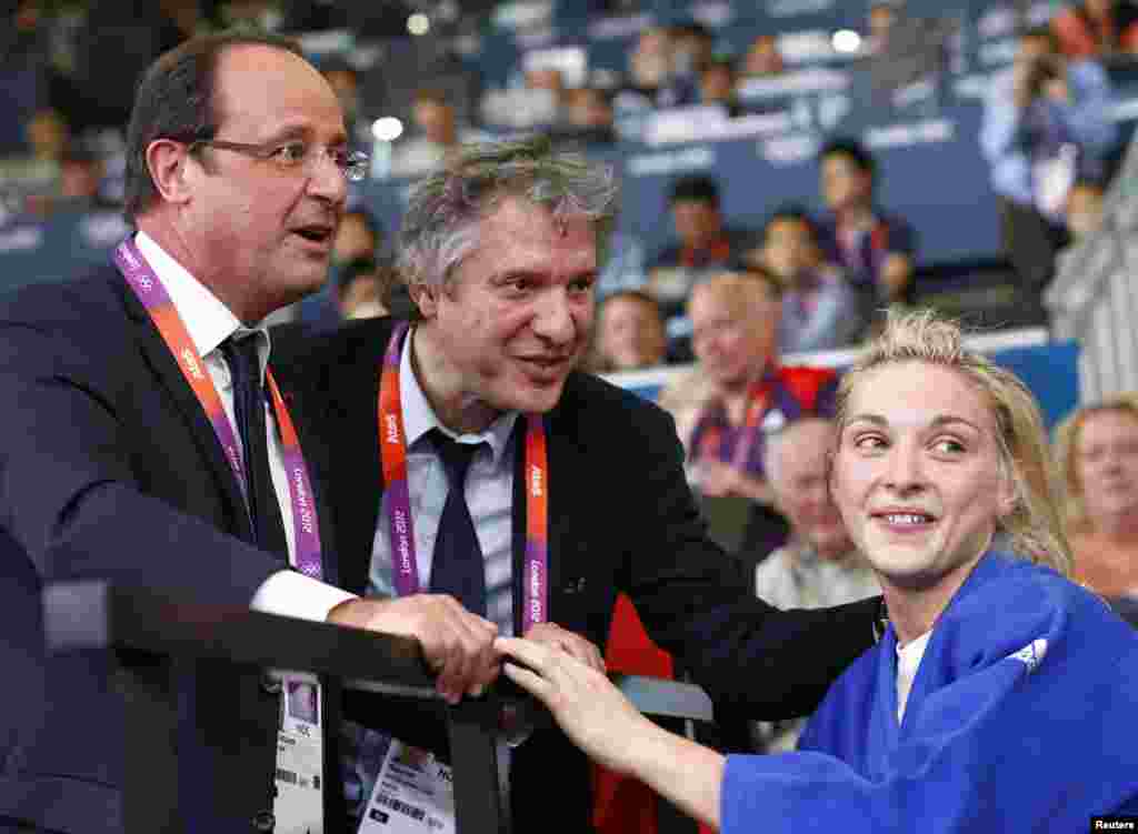 France's President Francois Hollande congratulates French athlete August 5, 2012.