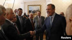 Russia's Foreign Minister Sergei Lavrov (R) meets with Syrian opposition leaders in Moscow July 11, 2012. 