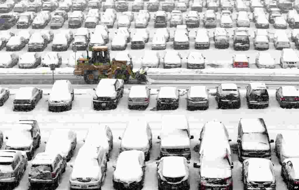 2013年3月5日，铲雪车在芝加哥奥哈拉国际机场的停车场清理积雪。