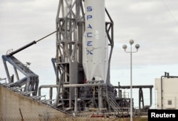 A remodeled version of the SpaceX Falcon 9 rocket rests on its pad as it is prepared for launch at the Cape Canaveral Air Force Station on the launcher's first mission since a June failure in Cape Canaveral, Florida, Dec. 20, 2015.