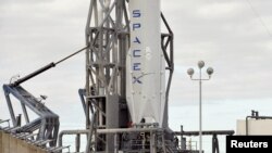 FILE - A SpaceX Falcon 9 rocket rests on its pad as it is prepared for launch at the Cape Canaveral Air Force Station on the launcher's first mission since a June failure in Cape Canaveral, Florida, Dec. 20, 2015.