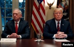 FILE - U.S. President Donald Trump speaks to the news media while gathering for a briefing from his senior military leaders, including Defense Secretary James Mattis (L), in the Cabinet Room at the White House in Washington, U.S., Oct. 23, 2018.