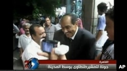 Field Marshal Mohammed Hussein Tantawi, on video seen widely on YouTube, strolls the streets of Cairo in a tailored dark suit instead of his military uniform.