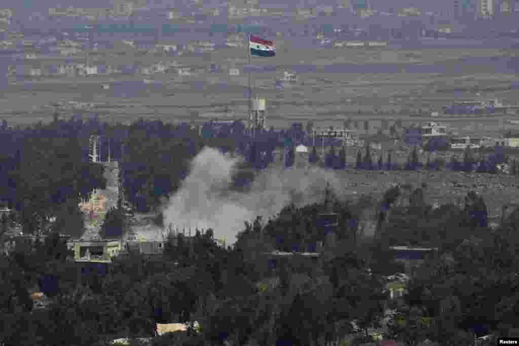 Smoke rises following an explosion on the Syrian side near the Quneitra border crossing between the Israeli-controlled Golan Heights and Syria Aug. 29, 2014.