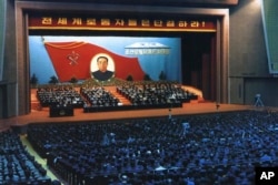 In this Oct. 10, 1980 photo provided by the Korea News Service (KNS), delegates attend a convention of North Korea's Workers' Party in Pyongyang, North Korea.
