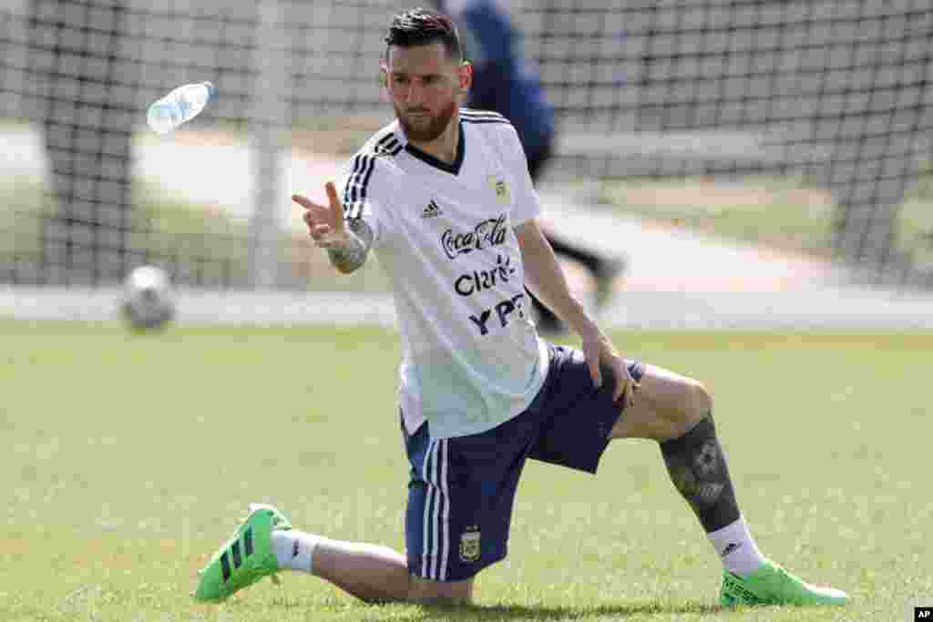 Lionel Messi throws a bottle of water during a training session of Argentina at the 2018 soccer World Cup in Bronnitsy, Russia.