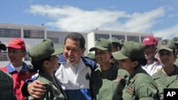 Venezuela's President Hugo Chavez (C) talks to soldiers as he attends a ceremony at the military academy in Caracas July 7, 2011