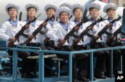 Navy personnel sit in front of a submarine-launched ballistic missile during a military parade on in Pyongyang, North Korea, to celebrate the 105th birth anniversary of Kim Il Sung, the country's late founder, April 15, 2017.