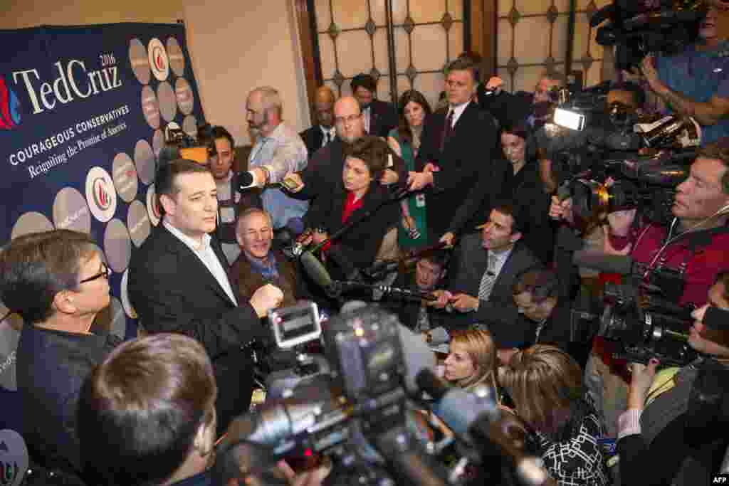 U.S. Republican presidential hopeful Sen. Ted Cruz speaks to the media with Texas Governor Greg Abbott and former governor Rick Perry following a campaign rally in Dallas, Texas, Feb. 29, 2016