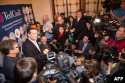 U.S. Republican presidential hopeful Sen. Ted Cruz speaks to the media with Texas Governor Greg Abbott and former governor Rick Perry following a campaign rally in Dallas, Texas, Feb. 29, 2016