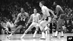 FILE - Boston's Sam Jones, left, gets past the Lakers' Jerry West (44) and drives along the baseline toward the basket in the teams' NBA playoff game in Los Angeles on May 2, 1968. Basketball Hall of Famer Jones died Dec. 30, 2021, at 88.