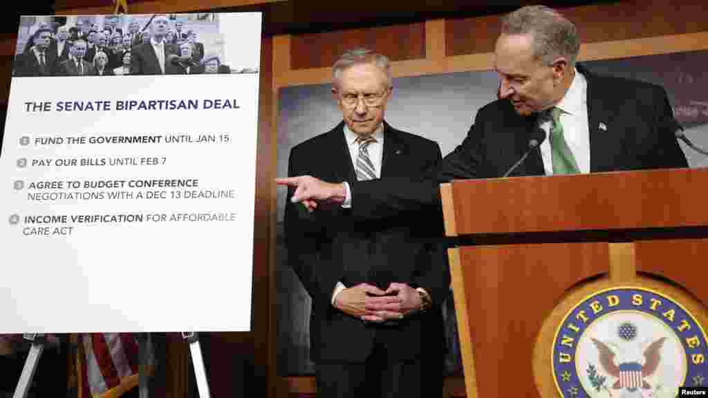 U.S. Senator Charles Schumer (D-NY) (R) and Senate Majority Leader Harry Reid (D-NV) appear at a news conference after passage of stopgap budget and debt legislation at the U.S. Capitol.