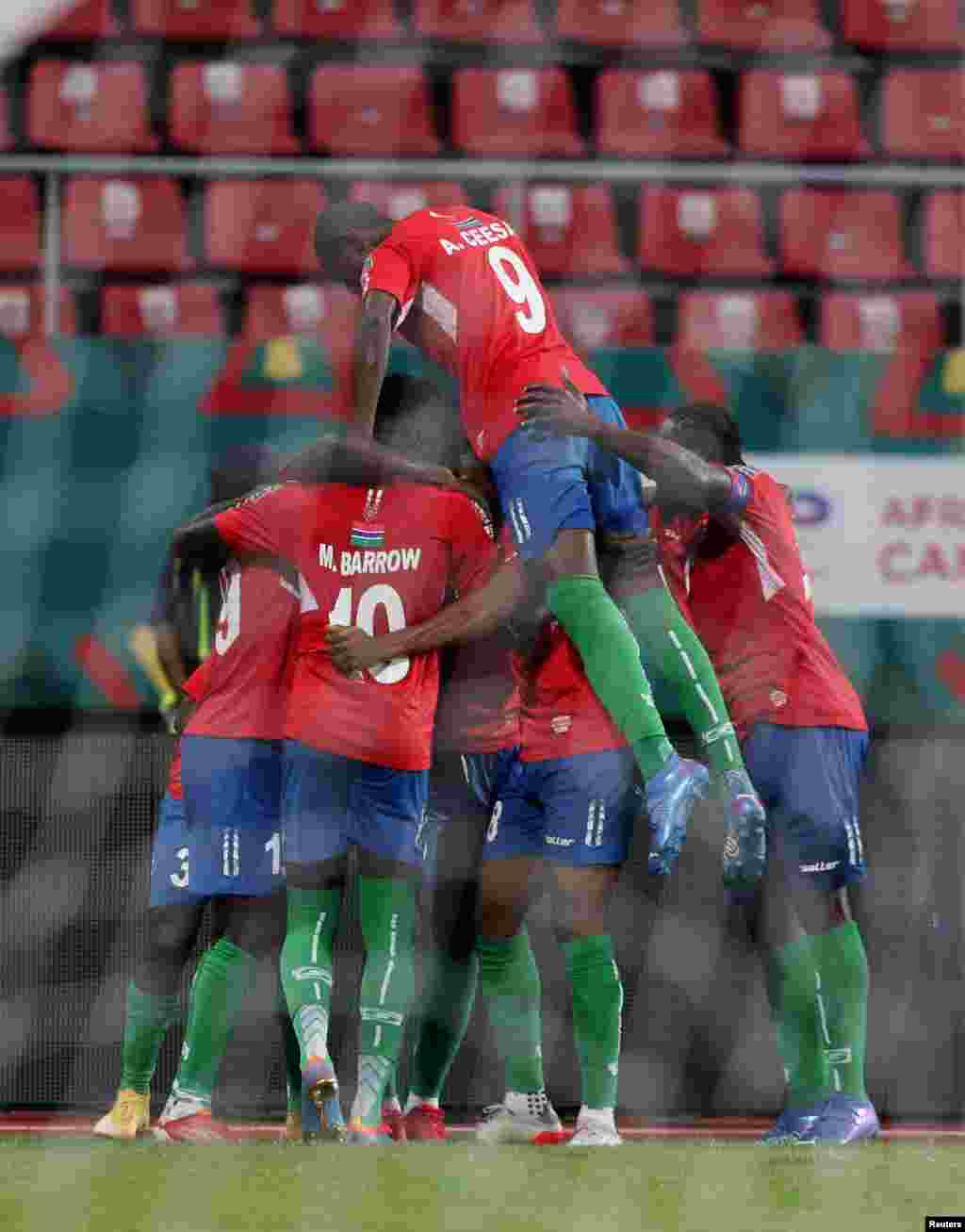 Gambia&#39;s Ablie Jallow celebrates scoring their first goal with teammates.