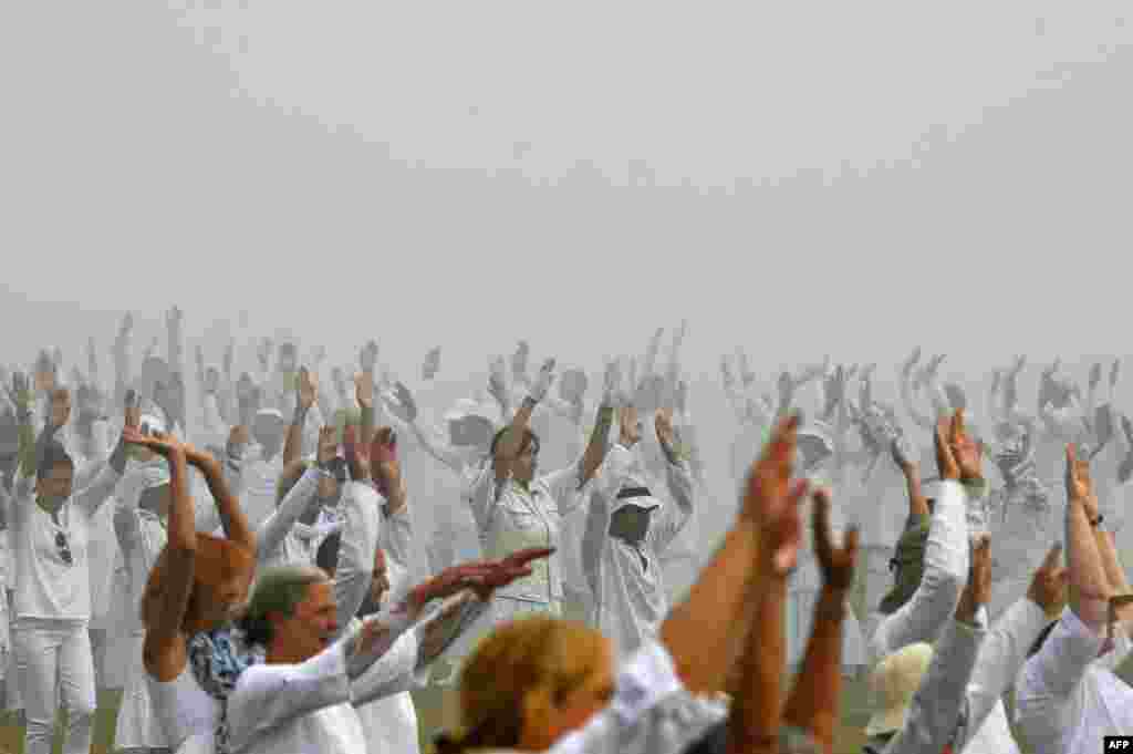 Members of an international religious movement called the White Brotherhood perform a special dance on the top of the Rila Mountain, near Babreka lake, Bulgaria.