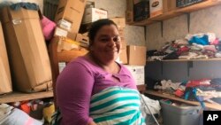 Piedad de Jesus Mejia sits in a storage room at the Senda de Vida migrant shelter in Reynosa, Mexico, June 30, 2018. Mejia and her husband, Isidro Sacasa, carried a hefty clear plastic folder from their home in Honduras with medical examiner's report and death records. Mejia said she and her husband and their children fled in April after receiving death threats and seeing two cousins slain in front of their home.