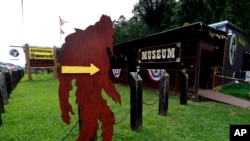 In this Aug. 8, 2019, photo, a cutout of a Bigfoot directs visitors to the entrance of Expedition: Bigfoot! The Sasquatch Museum in Cherry Log, Ga. 