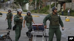 National Guard soldiers carry a stretcher outside of El Rodeo I prison during a riot inside the jail in Guatire, Venezuela, June 17, 2011