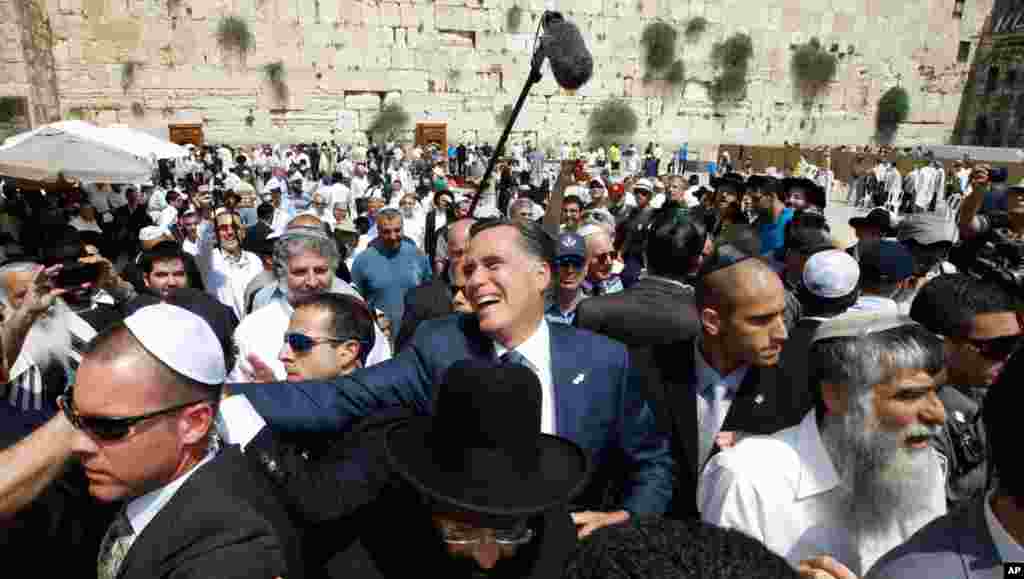 Romney greets the crowd after his visit to the Western Wall. 