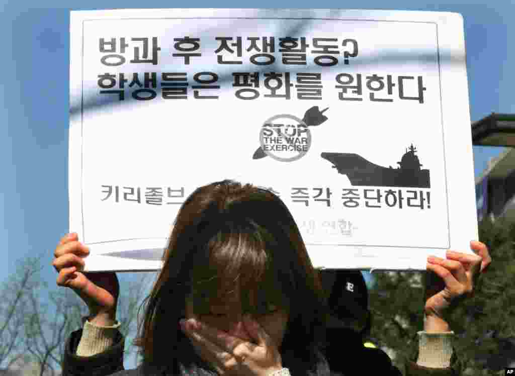 A South Korean college student weeps as she reads statements during a press conference denouncing the annual joint military exercises between South Korea and the United States, near the U.S. Embassy in Seoul, South Korea, March 10, 2013.