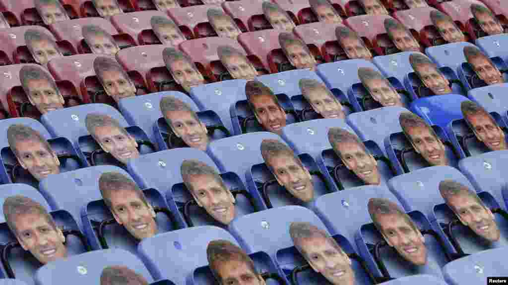 Masks of Aston Villa&#39;s former captain Stiliyan Petrov hang from the seats before their English Premier League soccer match against Wigan Athletic, May 19, 2013.