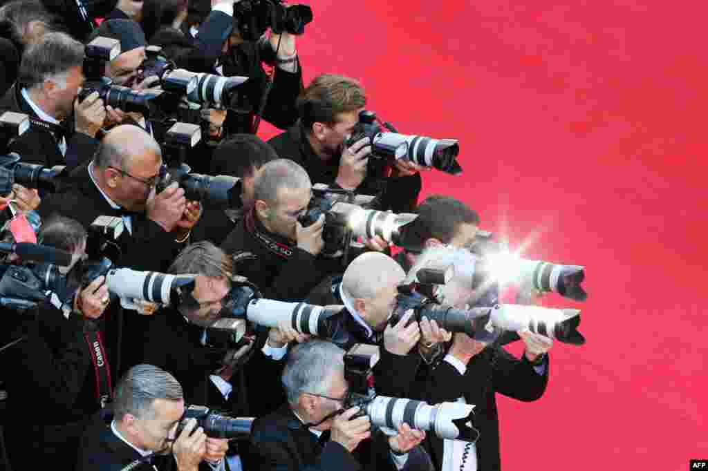 Photographers shoot pictures as guests arrive for the screening of the film 'Mr. Turner' at the 67th edition of the Cannes Film Festival in Cannes, southern France, May 15, 2014. 