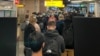 Passengers travelling from South Africa queue to be coronavirus disease (COVID-19) tested after being held on the tarmac at Schiphol Airport, Netherlands, Nov. 25, 2021.