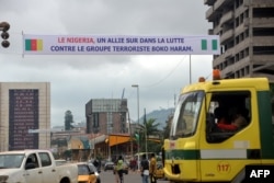 FILE - A banner reads 'Nigeria - an ally in the fight against terrrorist group Boko Haram' in Yaounde, Cameroon, July 28, 2015.