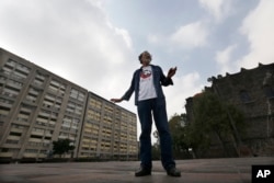 In this Sept. 18, 2018 photo, Enrique Espinosa, who was a medical student when he survived the 1968 Tlateloco massacre, shows the spot where he was when soldiers started shooting in Tlatelolco plaza, Mexico City.