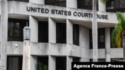FILE - A security guard walks past the C. Clyde Atkins US Federal Courthouse in Miami, Florida, on Jan. 20, 2022.