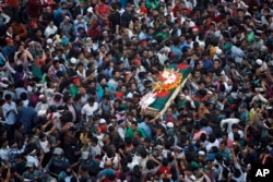 FILE - Bangladeshi mourners carry the coffin containing the body of blogger Ahmed Rajib Haider for funeral in Dhaka, Bangladesh, Feb. 16, 2013.