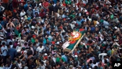 FILE - Bangladeshi mourners carry the coffin containing the body of blogger Ahmed Rajib Haider for funeral in Dhaka, Bangladesh, Feb. 16, 2013.