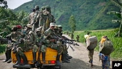 FILE - M23 rebels withdraw from the Masisi and Sake areas in eastern Congo, Nov 30, 2012.